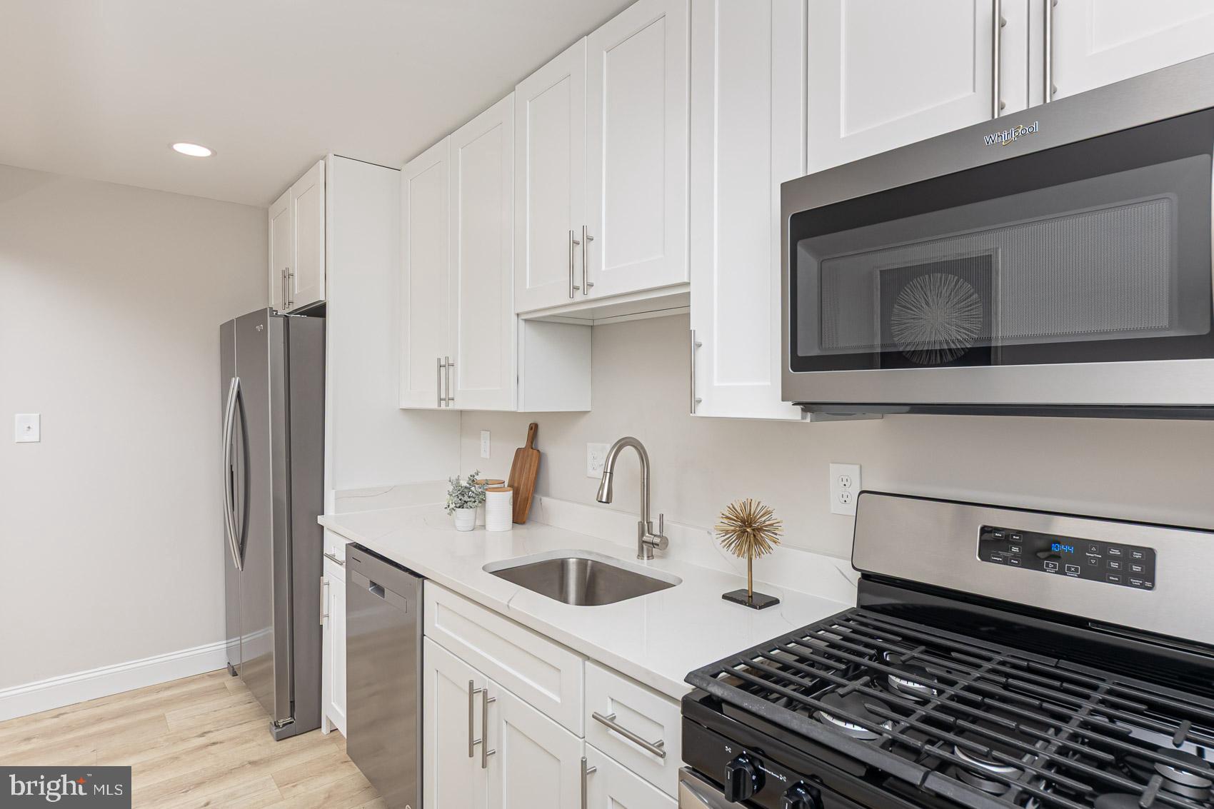 1015 Stamford Road Baltimore, MD 21229 - Photo 3 of 31 a kitchen with stainless steel appliances granite countertop a sink stove and refrigerator