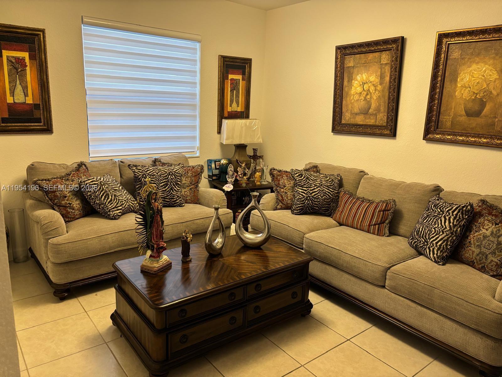23622 Southwest 115th Avenue Homestead, FL 33032 - Photo 1 of 4 a living room with furniture and a couch