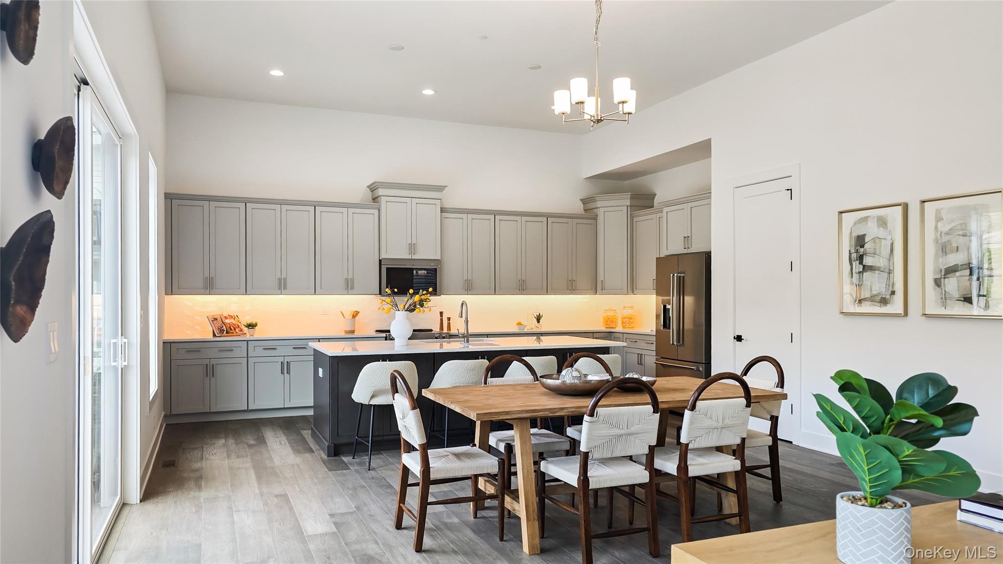 2069 Summit Loop, Unit 98 Carmel, NY 10512 - Photo 5 of 21 a dining room filled chandelier and wooden floor