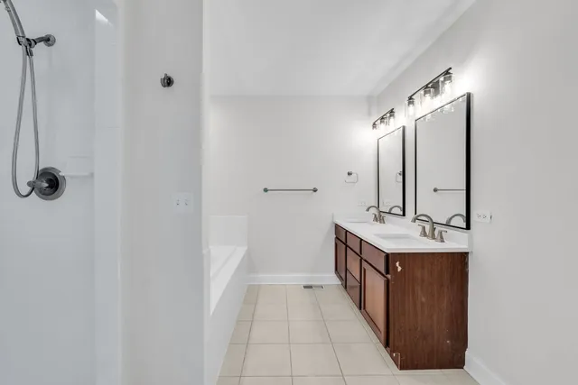 a bathroom with a double vanity sink and a mirror