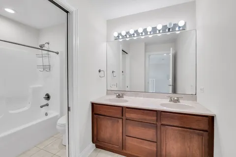 a bathroom with a double vanity sink and a mirror