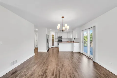 a view of kitchen with refrigerator and window