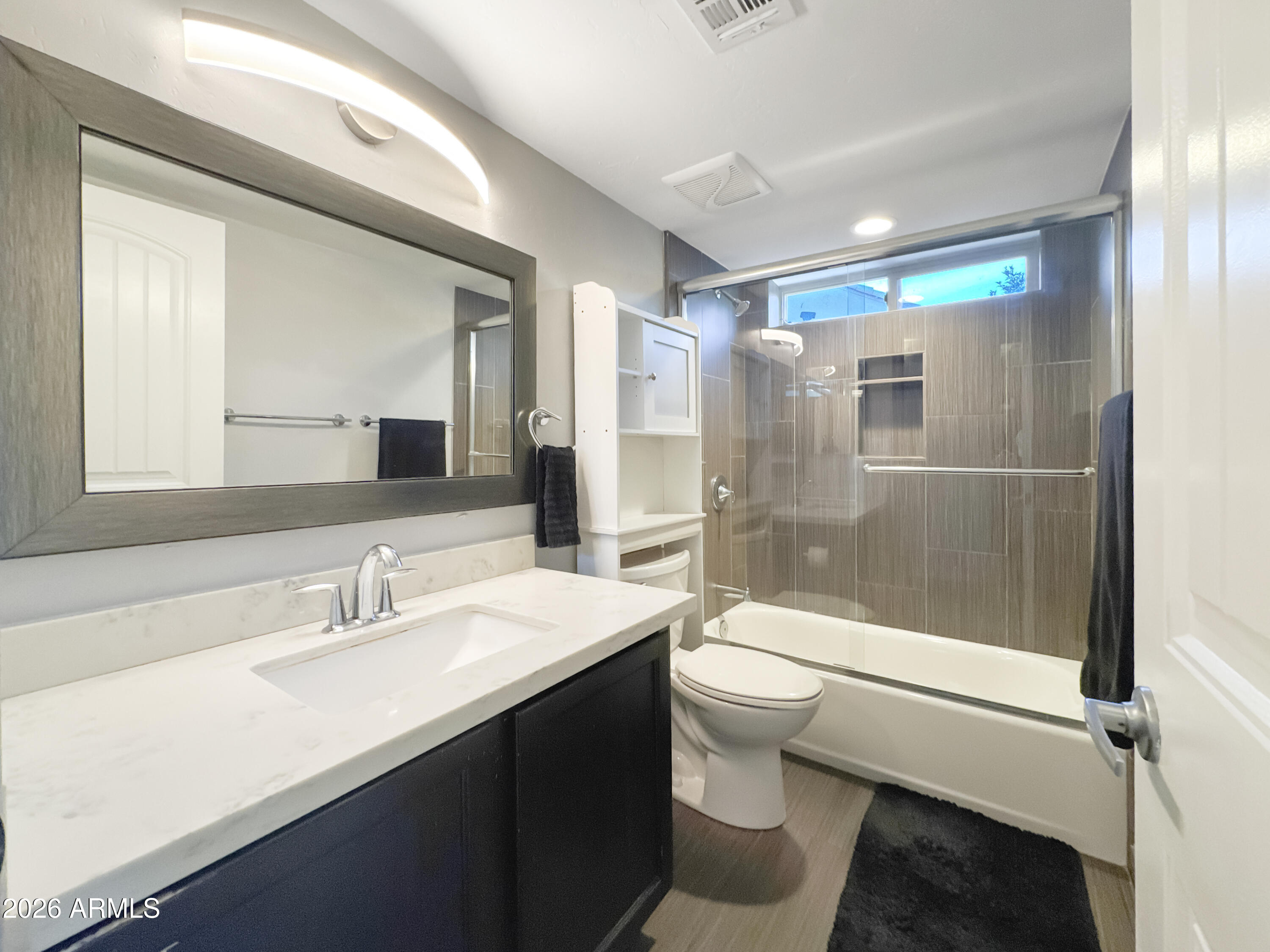 603 North Almar Circle Mesa, AZ 85213 - Photo 22 of 31 a bathroom with a sink a toilet a mirror and shower