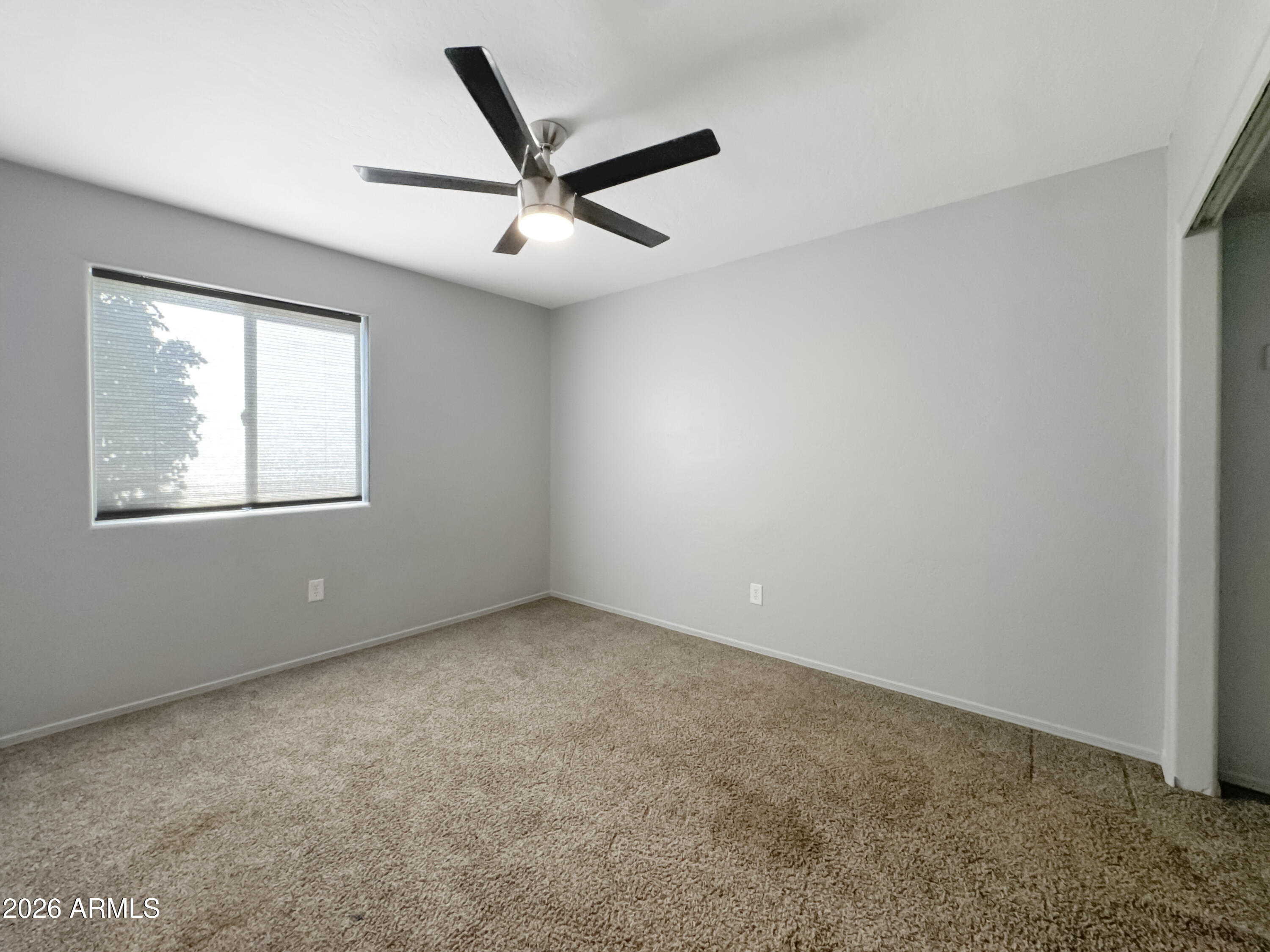 603 North Almar Circle Mesa, AZ 85213 - Photo 25 of 31 an empty room with a window and a fan