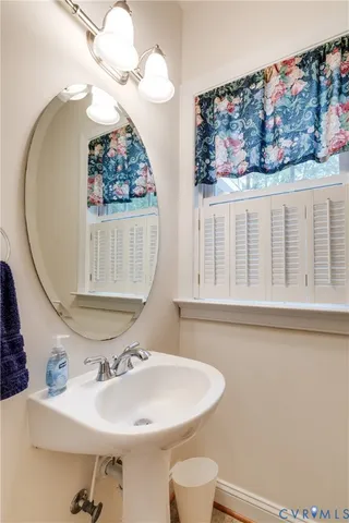 a bathroom with a sink a mirror and a toilet