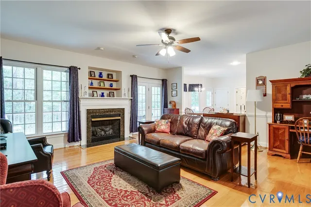 a living room with furniture a fireplace and a flat screen tv