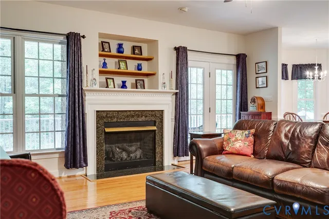 a living room with a couch a large window and a fireplace