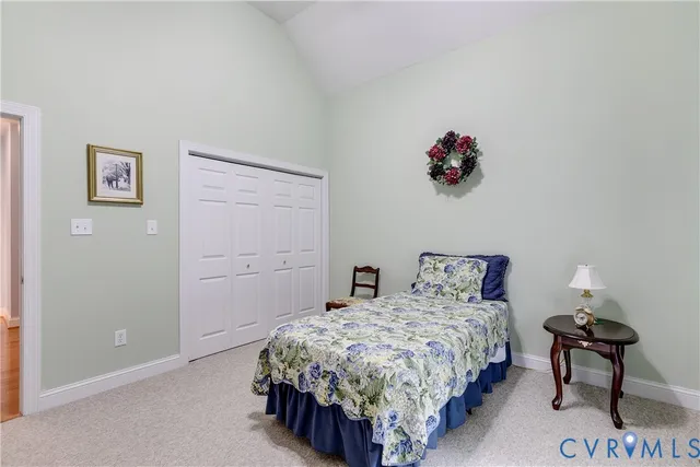 a bedroom with a bed and a potted plant