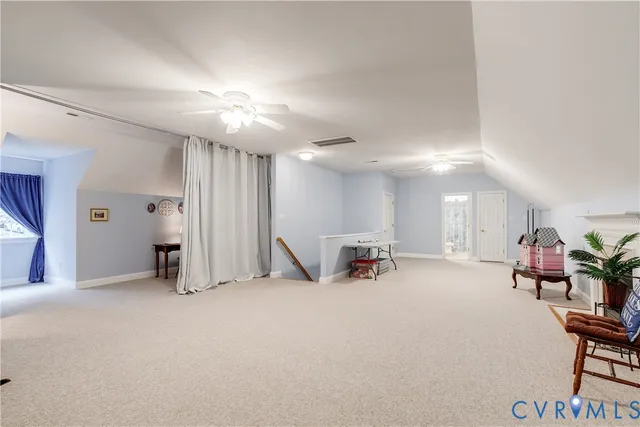 a view of a livingroom with furniture and a fan