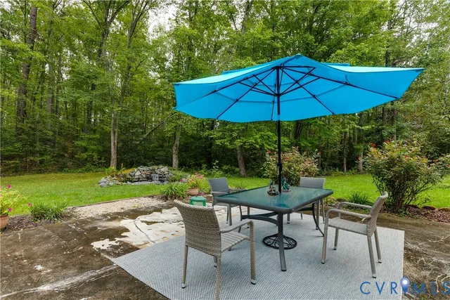 a view of a backyard with furniture and a garden