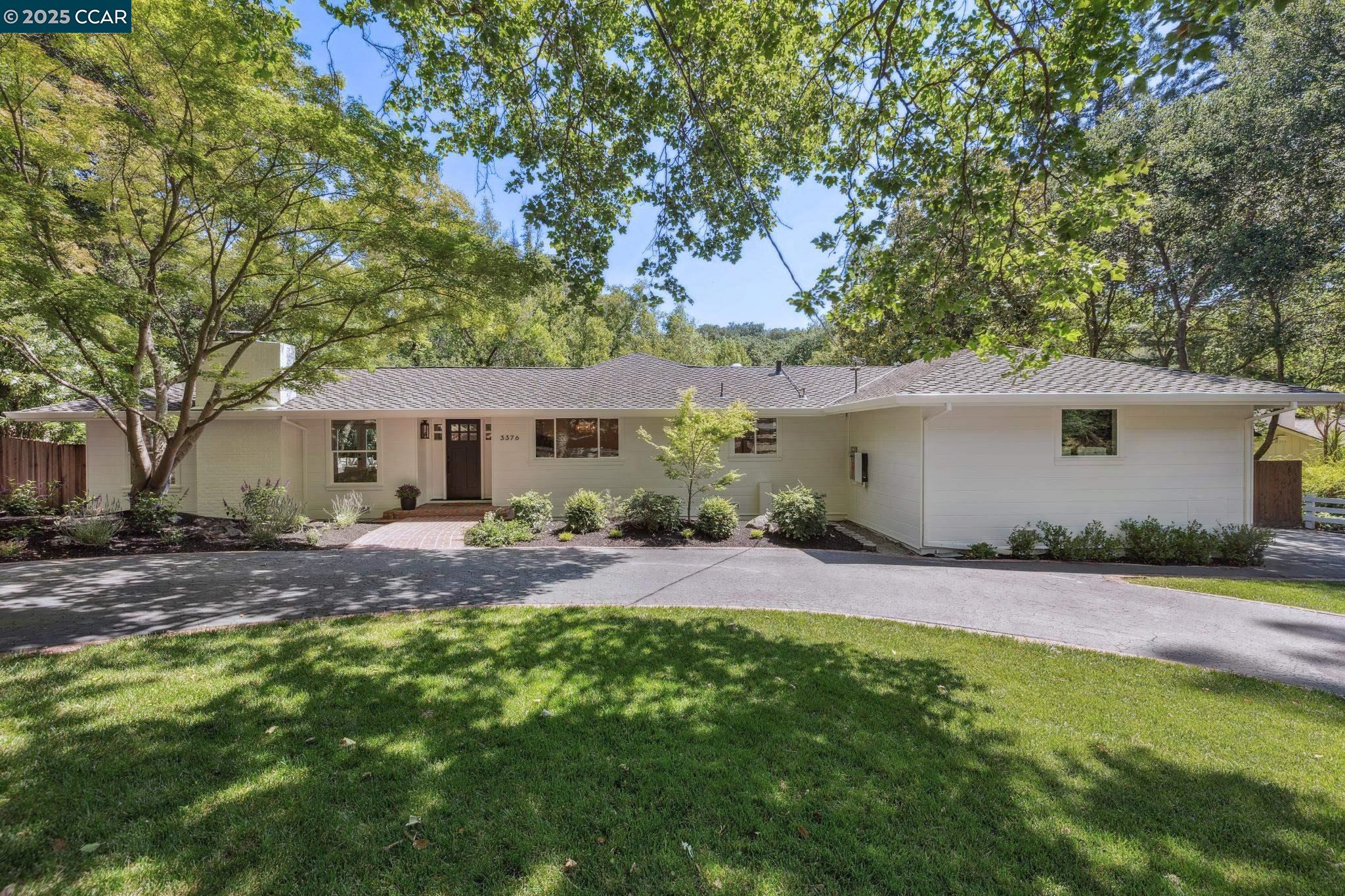 a front view of house with yard and green space