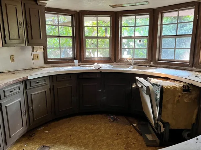 a kitchen with stainless steel appliances granite countertop a sink a stove and a microwave