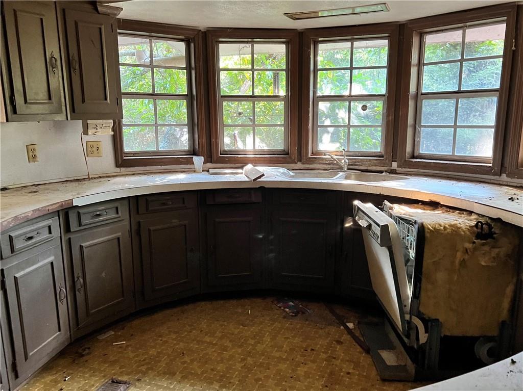 2467 Gum Creek Road Oxford, GA 30054 - Photo 2 of 6 a kitchen with stainless steel appliances granite countertop a sink a stove and a microwave
