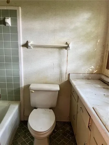 a bathroom with a granite countertop toilet sink and shower