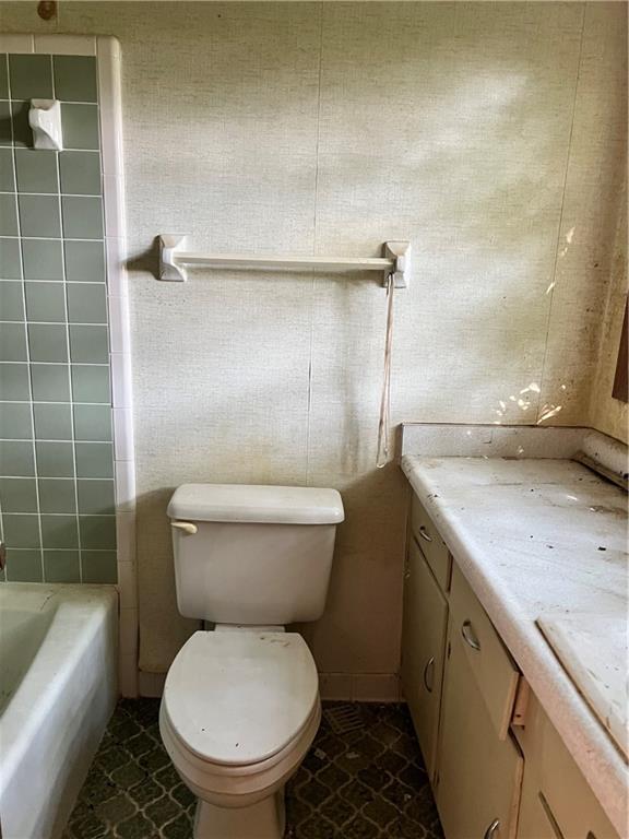 2467 Gum Creek Road Oxford, GA 30054 - Photo 5 of 6 a bathroom with a granite countertop toilet sink and shower