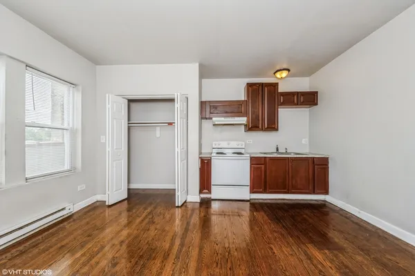 a view of kitchen with wooden floor and electronic appliances