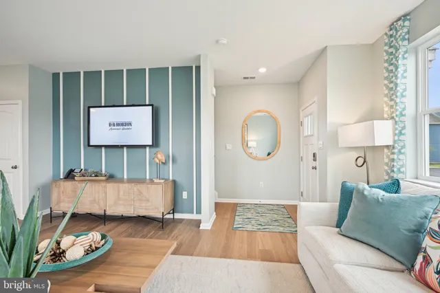 a living room with furniture and a mirror