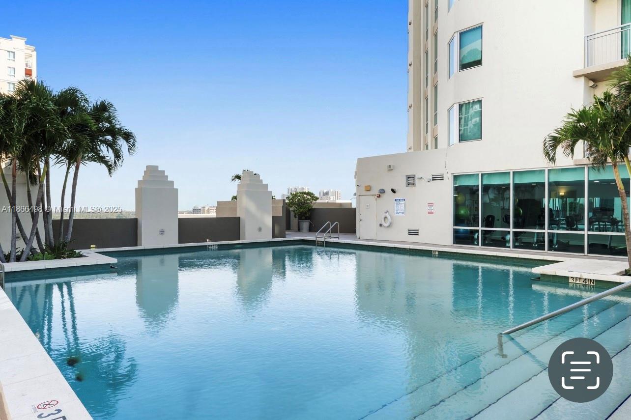 9055 Southwest 73rd Court, Unit 207 Miami, FL 33156 - Photo 20 of 22 a view of a swimming pool with a lake