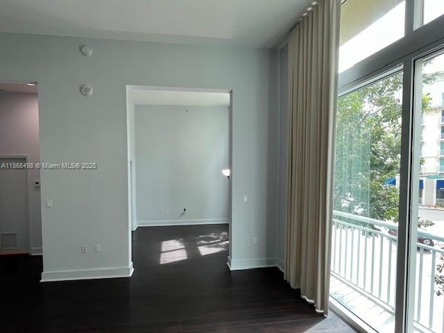 9055 Southwest 73rd Court, Unit 207 Miami, FL 33156 - Photo 3 of 22 a view of empty room with wooden floor and fan