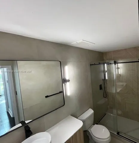 a bathroom with a toilet and a shower