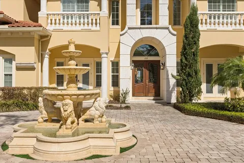 a view of a swimming pool with a lawn chairs under an umbrella