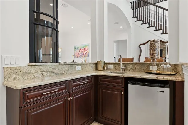 a kitchen with stainless steel appliances granite countertop a sink a stove and dishwasher