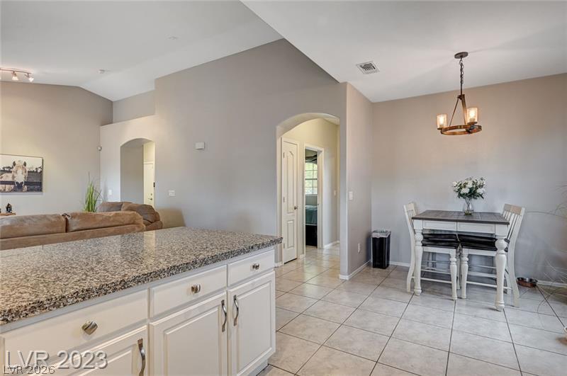 987 Cutter Street Henderson, NV 89011 - Photo 7 of 17 Functional island kitchen offers abundant counter space and seamless connection to the living area.