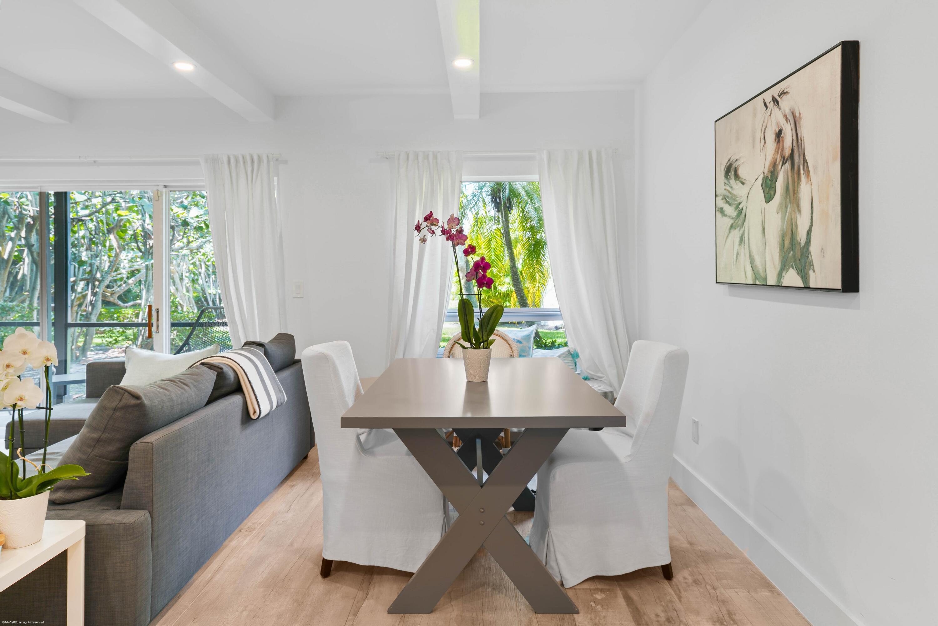 13334 Polo Club Road, Unit 234 Wellington, FL 33414 - Photo 9 of 41 a view of a dining room with furniture and a potted plant