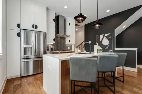 a kitchen with stainless steel appliances granite countertop a sink refrigerator and microwave