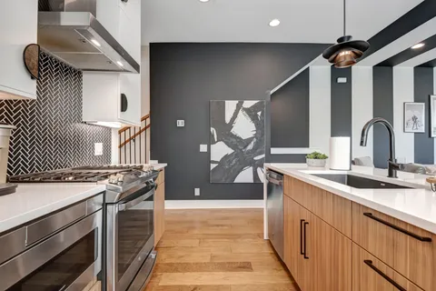 a kitchen with a sink stove and cabinets