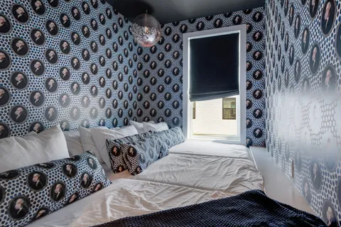 a living room with furniture a mirror and a fireplace