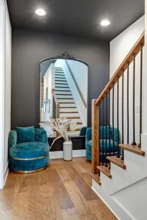 a bed sitting in a bedroom next to a window with lamp