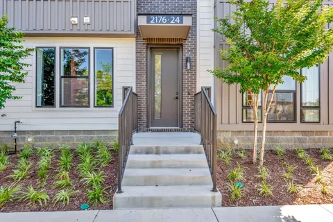 a front view of a house with a garden