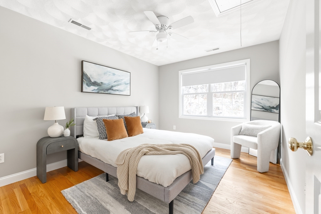 70 Sylvan Street, Unit 70 Melrose, MA 02176 - Photo 12 of 20 a bedroom with a bed and a large window