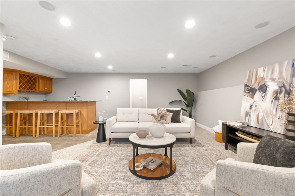 70 Sylvan Street, Unit 70 Melrose, MA 02176 - Photo 14 of 20 a living room with furniture a window and a fireplace