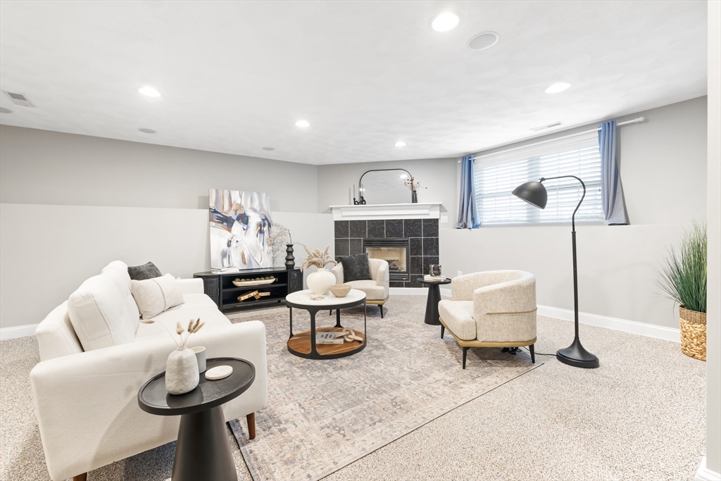 70 Sylvan Street, Unit 70 Melrose, MA 02176 - Photo 15 of 20 a living room with furniture and a fireplace