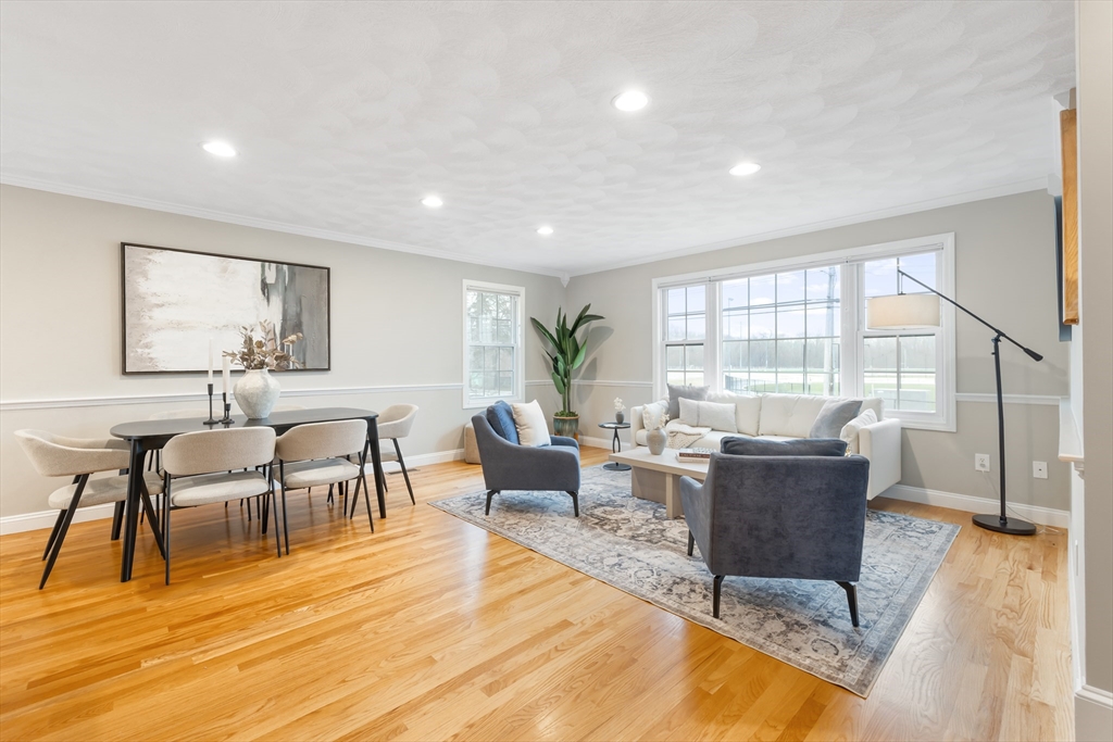 70 Sylvan Street, Unit 70 Melrose, MA 02176 - Photo 2 of 20 a living room with furniture wooden floor and a floor to ceiling window