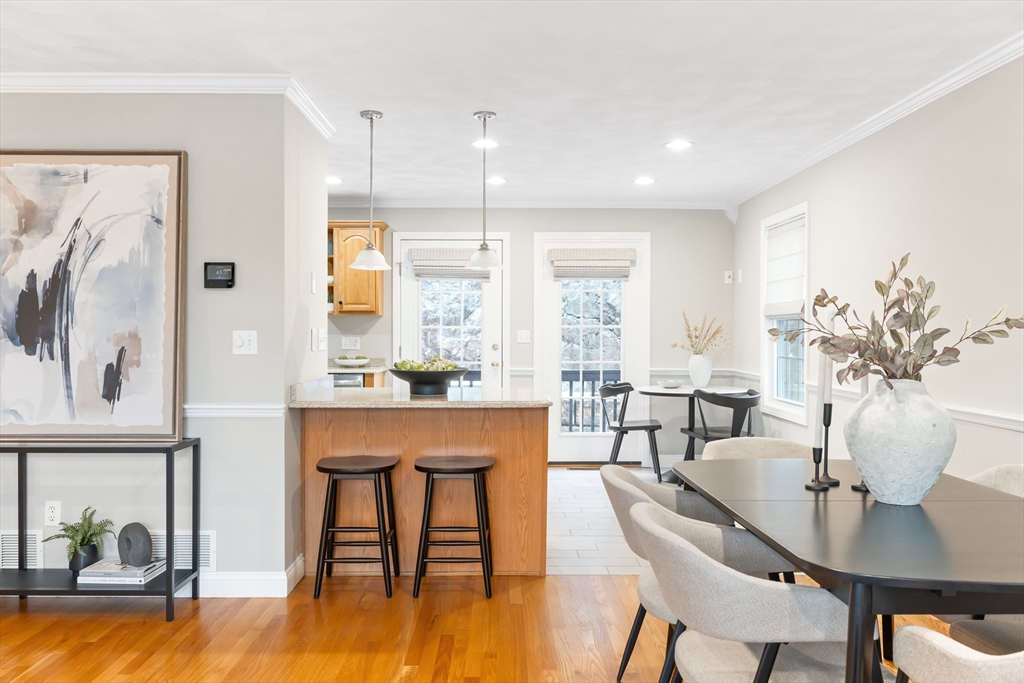 70 Sylvan Street, Unit 70 Melrose, MA 02176 - Photo 7 of 20 a view of a dining room with furniture a chandelier and wooden floor