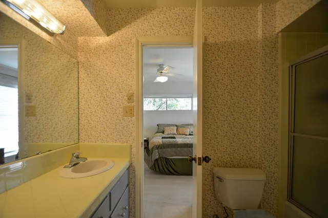 a bedroom with a bed and a lamp with window