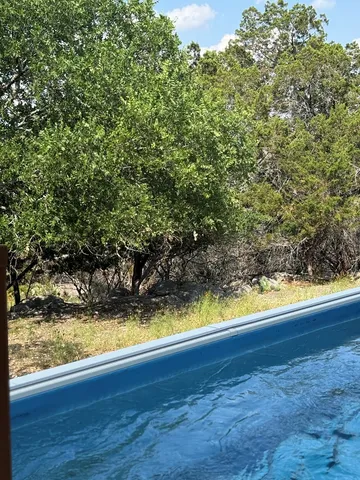 a backyard of a house with yard and outdoor seating
