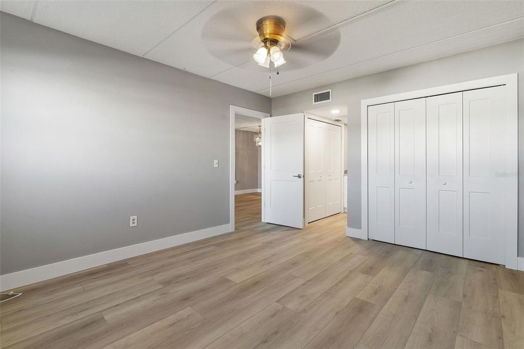 1 Boca Ciega Point Boulevard, Unit 113 St. Petersburg, FL 33708 - Photo 14 of 36 a view of an empty room and window and a chandelier fan