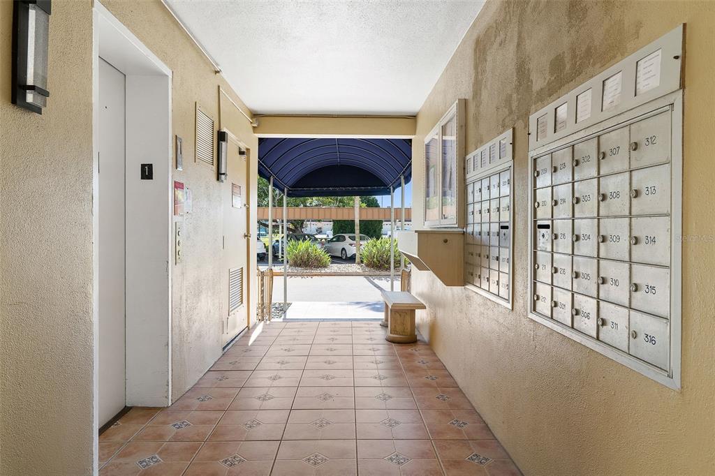 1 Boca Ciega Point Boulevard, Unit 113 St. Petersburg, FL 33708 - Photo 26 of 36 a view of a porch with dining table and chairs