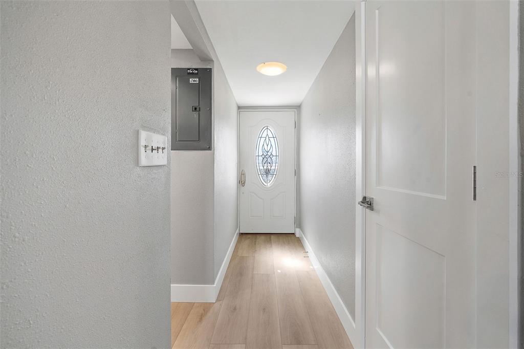 1 Boca Ciega Point Boulevard, Unit 113 St. Petersburg, FL 33708 - Photo 4 of 36 a view of hallway with wooden floor