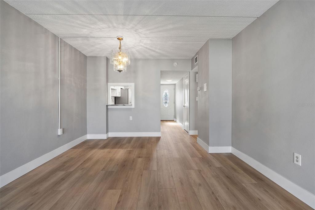 1 Boca Ciega Point Boulevard, Unit 113 St. Petersburg, FL 33708 - Photo 5 of 36 wooden floor in an empty room with a window