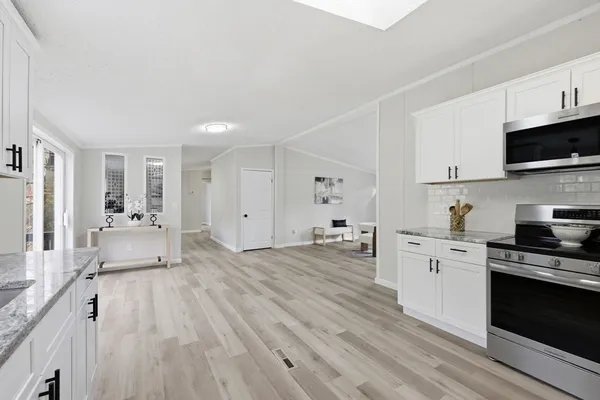 a kitchen with a sink cabinets and window