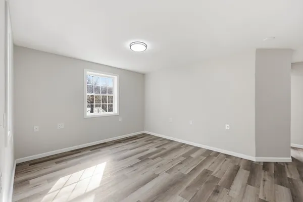 a bathroom with a toilet a sink a mirror and vanity