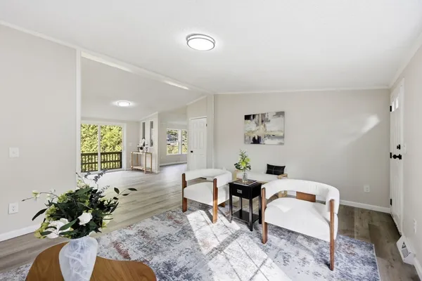 a large white kitchen with sink and cabinets