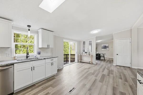 a kitchen with a stove a refrigerator and a sink