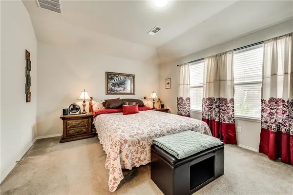 a bed sitting in a bedroom next to a window