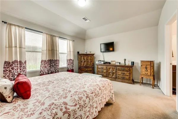 a bedroom with a bed and dresser